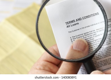 Hands Holding Magnifying Glass Reading Terms And Conditions Of Loan Agreement