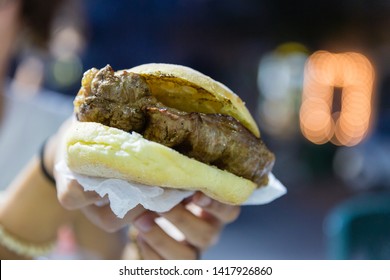 Hands Holding Meat Sandwich. Catania Street Food (Sicily)