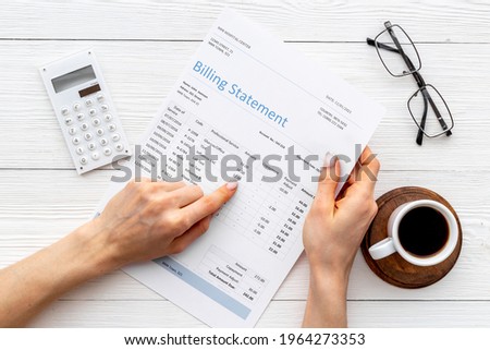 Hands holding medical billing statement. Payment for health care service
