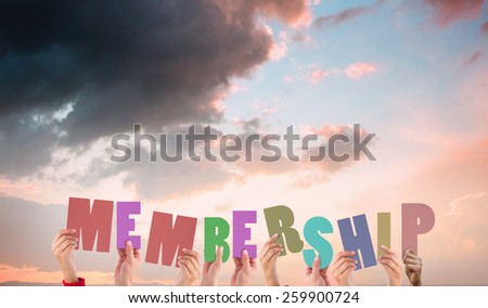 Hands holding up membership against orange and blue sky with clouds