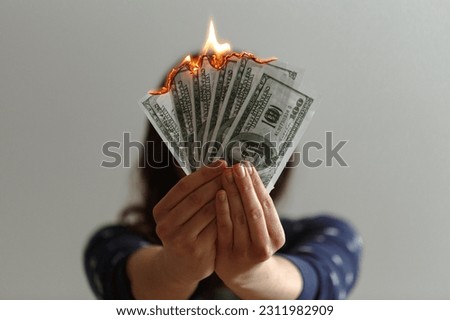 hands holding money aflame get