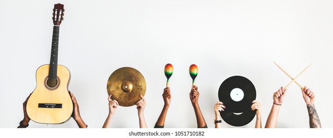 Hands holding music instruments - Shutterstock ID 1051710182