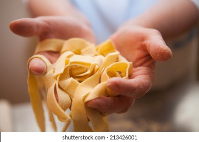 Hands holding noodles