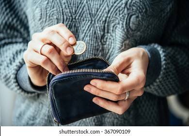 Hands Holding One Euro Coin And Small Money Pouch