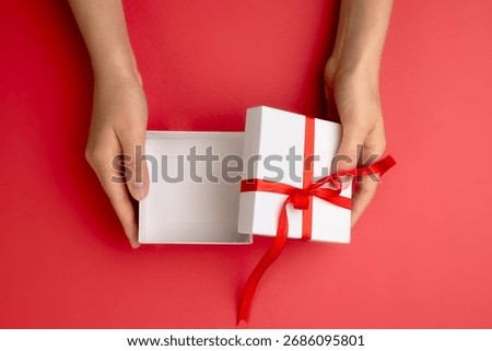 Hands holding opened empty gift box top view,Christmas present display,mockup,template. Product promotion container.