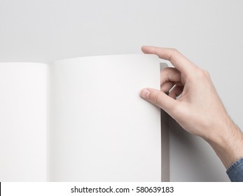 Hands holding opened Notebook. Blank paper Mock-up / Close-up