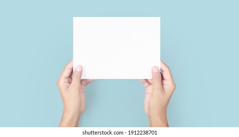 Hands holding paper blank for a letter paper - Shutterstock ID 1912238701