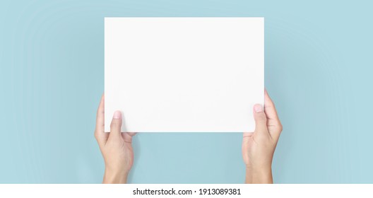 Hands Holding Paper Blank For A Letter Paper