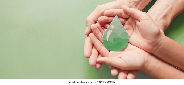 Hands Holding Paper Cut Green Oil Drop, CSR, Alternative Biofuel Renewable Green Energy Concept  