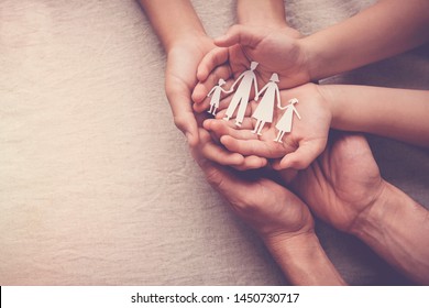 hands holding paper family cutout, family home, foster care, world mental health day, Autism support,homeschooling, budgeting cost of living, inflation concept - Powered by Shutterstock