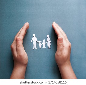 Hands Holding Paper Family Cutout, Social Distancing Concept, Covid19  On The Blue Color Background, Family Protection