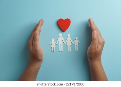 hands holding paper family cutout, life health insurance, social distancing concept, covid19,  on the blue color background, family protection                                - Shutterstock ID 2217372833