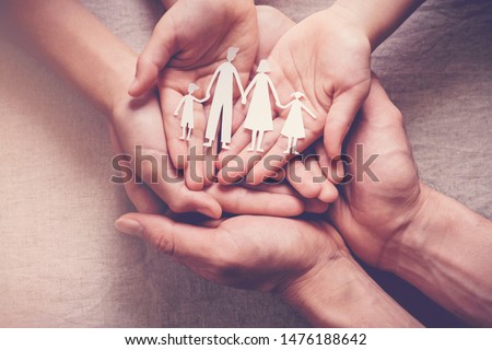 hands holding paper family cutout, family home, foster care, world mental health day, Autism support,homeschooling, budgeting cost of living, inflation concept