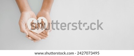 hands holding paper family cutout, family home, adoption foster care, homeless support , mental health, homeschooling , cost of living during recession concept