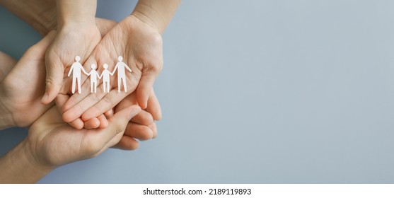 Hands holding paper family cutout,adoption foster care, LGBT family mental health, life insurance. volunteer community concept - Powered by Shutterstock