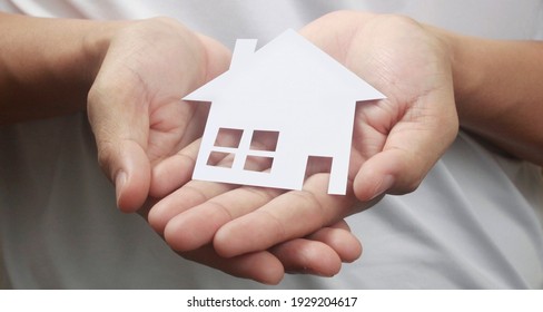 Hands Holding Paper House, Family Home And Protecting Insurance Concept