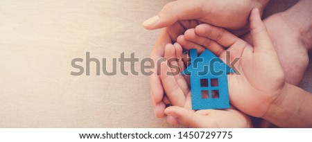 hands holding paper house, family home, homeless housing crisis, economic depression, mortgage concept
