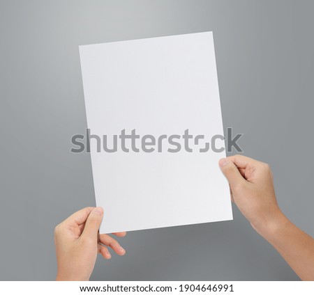 Hands holding paper resume for job application