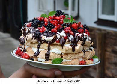 Hands Holding Pavlova Birthday Cake Covered With Different Kinds Of Fresh Fruit