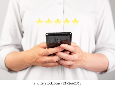 Hands Holding Phone For Giving Good Feedback. Woman Submitting Five Star Assessment. Consumer Satisfaction Survey. Positive Opinion. Goods, Service, Hotel, Application Rating. High Quality Photo