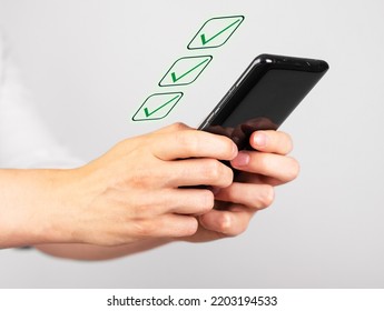 Hands Holding Phone For Online Survey, Test Taking. Questionnaire, Quiz On Internet. Smartphone With Ticks. Checklist Box. High Quality Photo