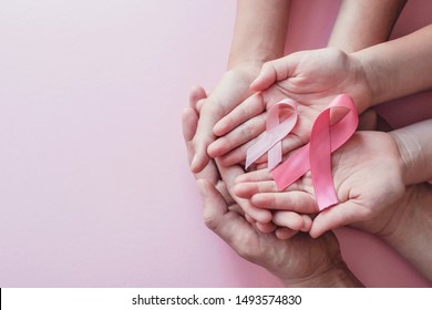 hands holding pink ribbons on pink background, Breast cancer awareness and October Pink day, world cancer day, national cancer survivor day - Shutterstock ID 1493574830