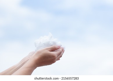 Hands holding polyester staple fiber with blue sky background