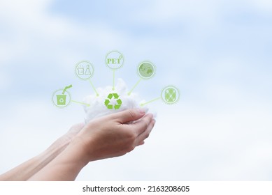 Hands holding polyester staple fiber with blue sky background. Recycle icon, sustainable icon and Bottle icon. Chemical concept.