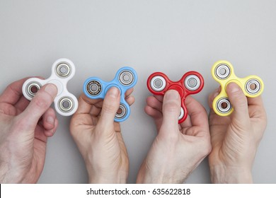 Hands holding popular fidget spinner toy