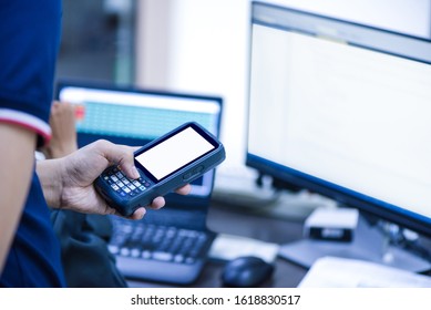 Hands Holding Portable Barcode Scanner In Warehouse 