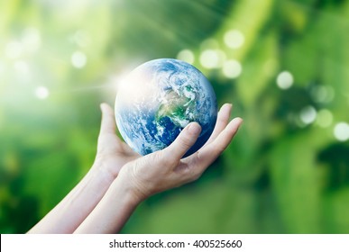 Hands holding and protect earth on nature background, Elements of this image furnished by NASA