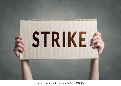 Hands holding protest signs. Workers going on Strike. - Shutterstock ID 683350906