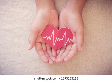 Hands Holding Red Heart With Cardiogram, Health Care, Life Insurance Business Concept, World Heart Day, World Health Day, Praying Concept