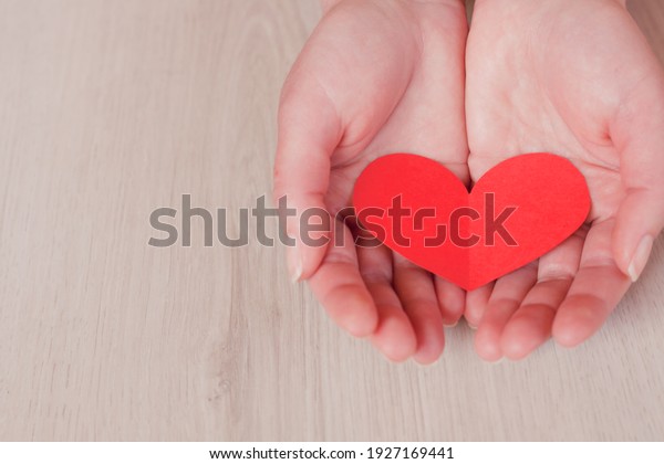 hands holding red\
heart, health care, love, organ donation, mindfulness, wellbeing,\
family insurance and CSR concept, world heart day, world health\
day, National Organ Donor\
Day.