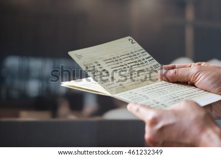 hands holding saving account passbook, book bank on a bank office background