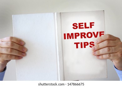 Hands Holding A Self Improvement How To Book