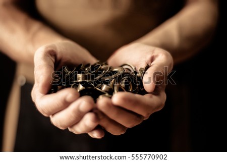 Hands holding set of cringles. Man manufacture concept
