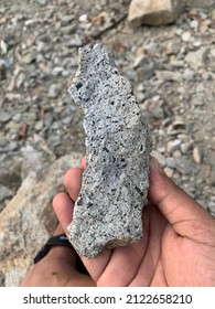 Hands holding sharp stone shards