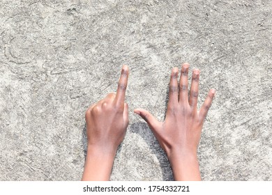 Hands Holding Up Six Fingers Over Fret Concrete Background