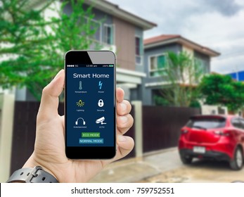 hands holding smart phone with app smart home on blurred house as backgrounds