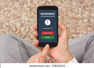 Hands Holding Smart Phone With Virus Alert On Screen. All Screen Content Is Designed By Me