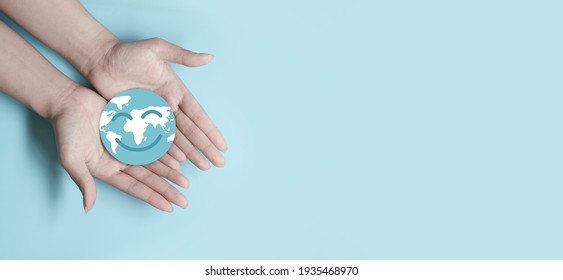 Hands holding smile earth paper cut, save planet, earth day, sustainable living, ecology environment, climate emergency action, world environment day concept, illustration for global warming content - Shutterstock ID 1935468970