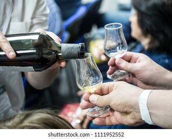 Hands Holding A Snifter Glass Filled With Whisky, Whisky Tasting Event