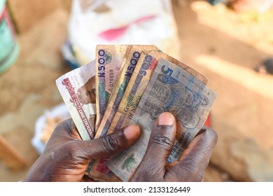 Hands Holding Spread Of Multiple Nigerian Naira Notes, Cash, Currency Or Money In An Outdoor Environment