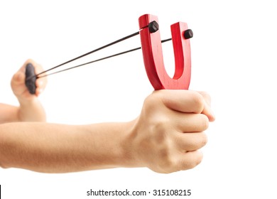 Hands holding a stretched slingshot with a rock in it isolated on white background