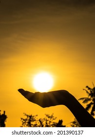 Hands Holding The Sun At Sunset