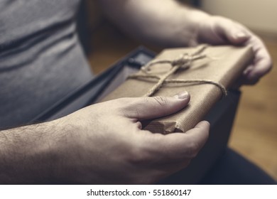 Hands Holding Suspicious Package. Bribe And Corruption Concept.