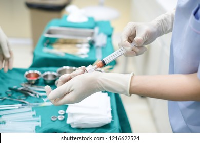 Hands Holding Syringes For Transfer Fat While Operating