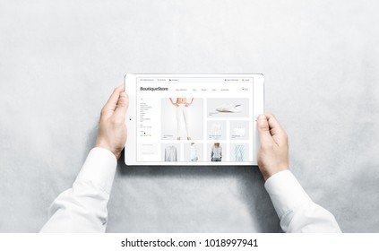 Hands Holding Tablet With Fashion Webstore Mock Up On Screen, Isolated. Clothing Web Page Interface Mockup. Internet Website Online Template On The Device Display.