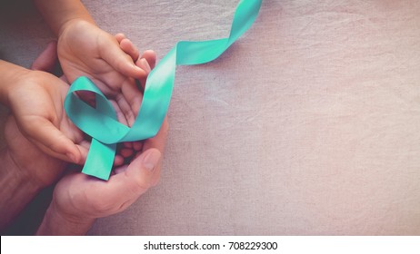 Hands Holding Teal Ribbon, Toning Panoramic Banner Background, Ovarian Cancer, Cervical Cancer, Pcos And Sexual Assault Awareness